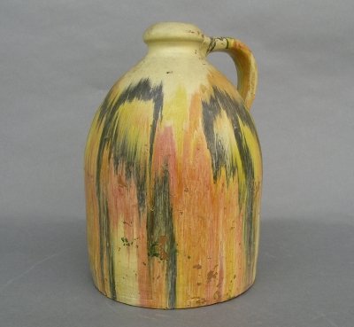 Painted jug: A turn of the century Redware jug with multi-color hand painted decoration. Wear and some flaking. 10 1/2" high. ESTIMATE $50-100