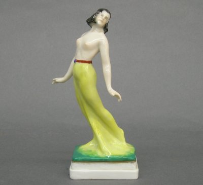 Art Deco figure: An Art Deco porcelain figure of a female dancer, by Karl Ens, Rudolstadt. Molded body with painted decoration. Printed and impressed marks. Slight wear, damage on 3 finger tips. 6 1/2" high. ESTIMATE