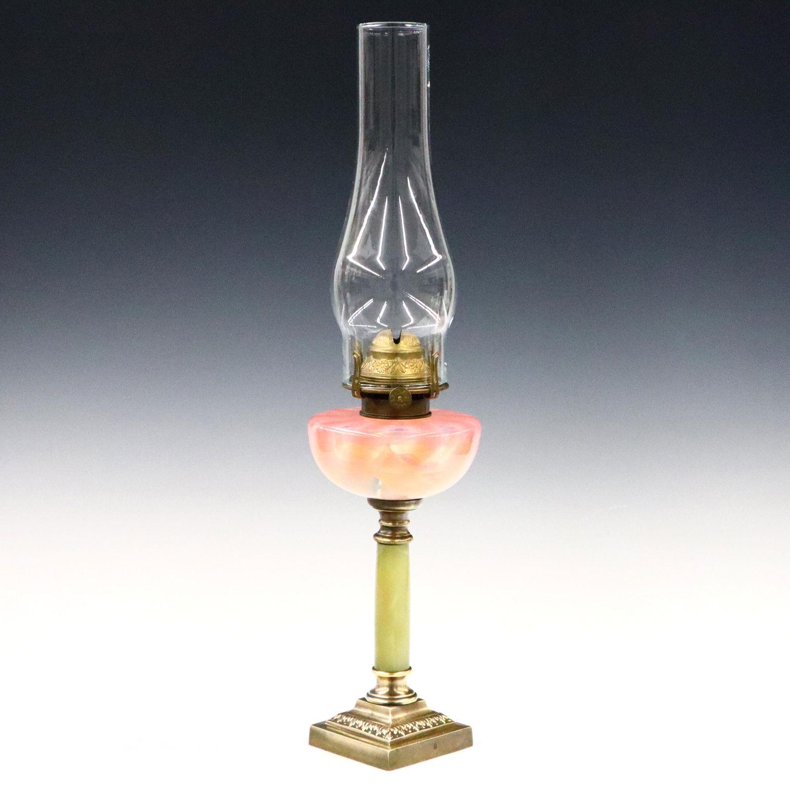 Victorian Oil Lamp: A late 19th century oil lamp. Ribbed Pink opalescent font, Green Onyx column, and molded Brass base. Minor wear. 20 1/2" high overall. ESTIMATE $100-200