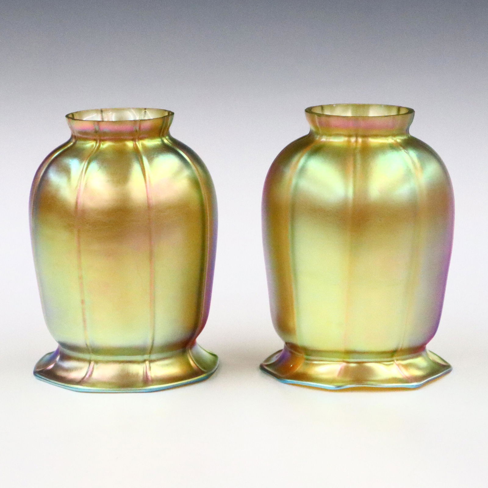 2 Art Glass Shades: Pair of early 20th century Steuben Art Glass Shades. Molded bodies with flared rims and Gold Aurene decoration. Unmarked. Minor wear. Each 5 1/4" high with 2 1/4" fitters. ESTIMATE $100-200