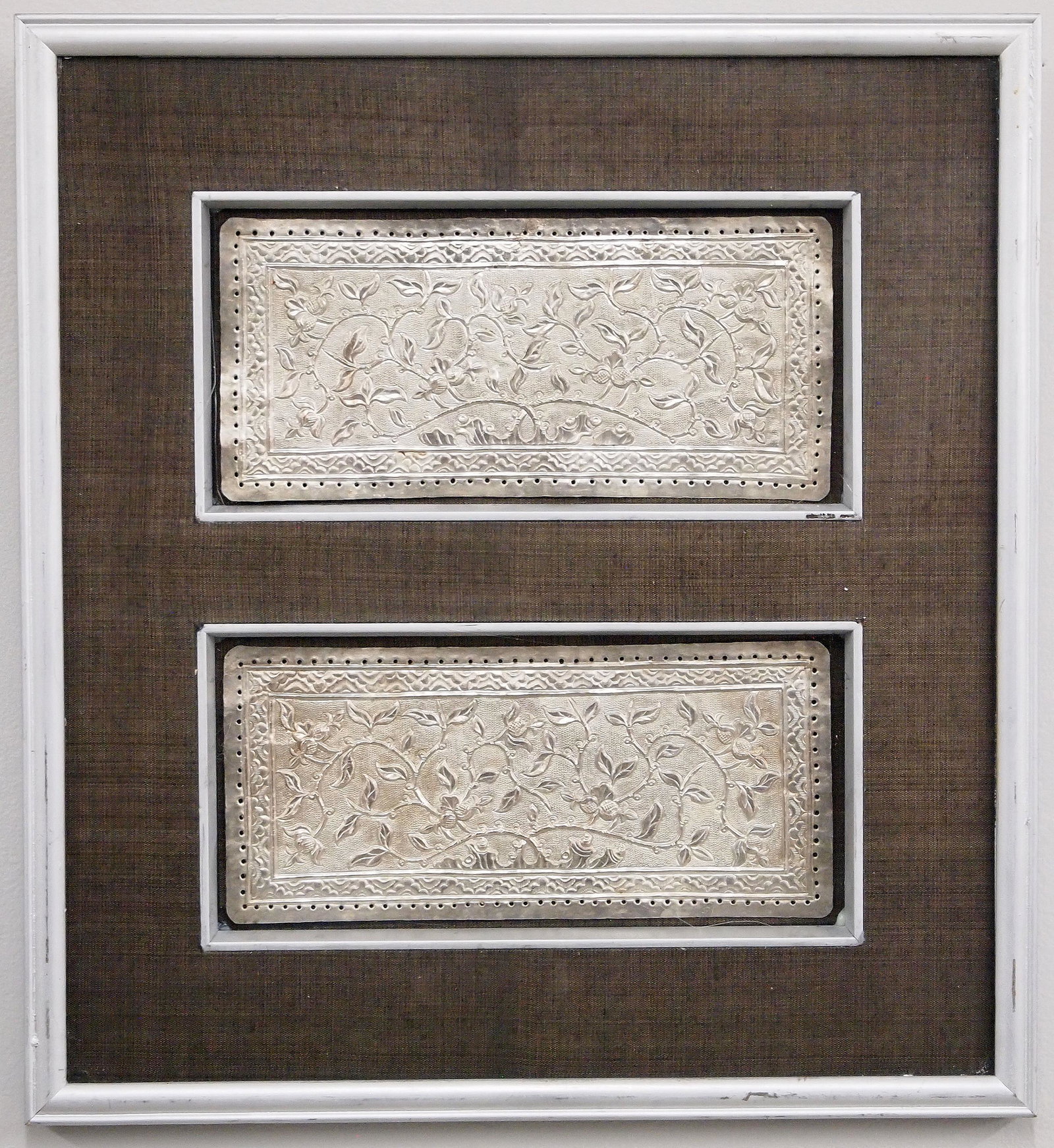 Indonesian Silver Wedding Plaques: Indonesian Silver Wedding Plaques. Originally stitched to formal attire, featuring embossed decoration scrolling vines and geometric borders. Minor wear. Each plaque measures 7 1/2 x 3 1/2" high, fram