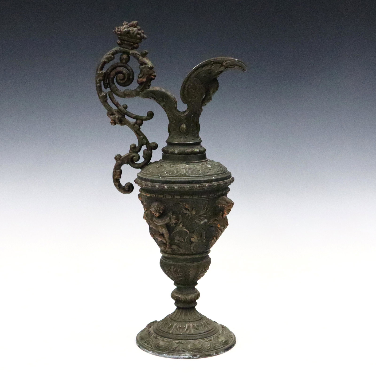 Italian Spelter Ewer: A turn of the century Italian Spelter ewer. Neoclassical design with scrolled handle and figural decoration. Old finish with wear and surface corrosion. 16 1/2" high. ESTIMATE $100-150