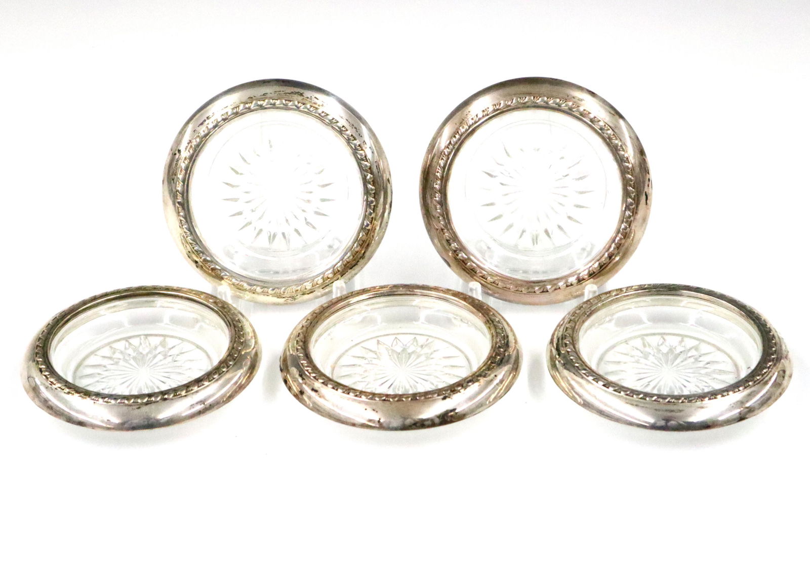 5 Crystal Coasters: Five 20th century Crystal coasters with Sterling Silver rims. Unmarked, minor wear. Each 4" in diameter. ESTIMATE $50-75