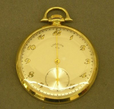 Ford Presentation 10 kt pocket watch: A Ford Motor Company 1957 35 Year Presentation pocket watch in a 10 kt Gold open face case. Lord Elgin 21 jewel 12 size movement. Slight wear. ESTIMATE $200-300