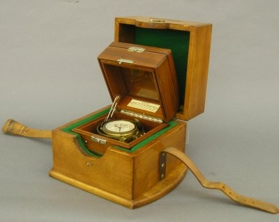 Hamilton Marine Chronometer: A 20th century Hamilton Model 22, 21 jewel Marine Chronometer. Back of movement marked "U S Navy-BU. Ships 1943". Painted metal dial with seconds bit and wind indicator. Mahogany case with double hing