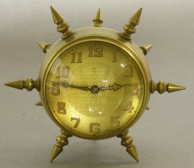 Brass desk clock: A turn of the century Brass Mace form desk clock. 8-day time only movement. Marked "BOXAWATCHMY SWISS". Minor wear. 4" high. ESTIMATE $100-200