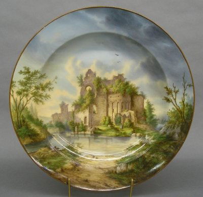 KPM porcelain charger: A good 19th century KPM porcelain charger. Finley hand painted scenic decoration with European ruins. Printed marks with Scepter and KPM monogram, also includes numerous early paper labels. Slight sur