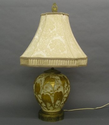 Phoenix Glass lamp: A mid 20th century Phoenix Glass table lamp. "Lovebirds pattern" in Custard color molded glass with gilt bird decorations on a brass base with silk shade, and original Lovebird finial. Slight wear. 31