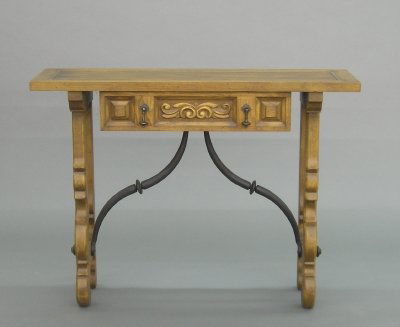 Oak side table: A 20th century Spanish style Oak side table by Hekman. Molded top with single drawer and shaped legs with Iron stretcher. Minor wear. 40 x 12 1/2 x 30" high. ESTIMATE $400-600