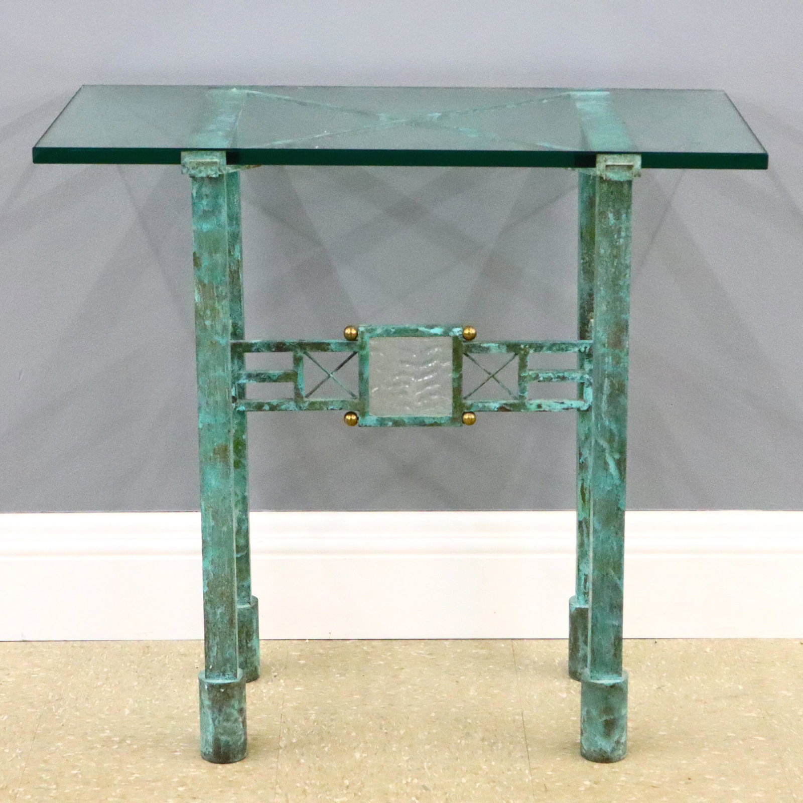 Bronze Hall Table: A late 20th century hall table. Patinated Bronze construction with gilded detail, central stretcher with inset glass panel and a plate glass top. Minor wear, tiny edge chip to top. 32 x 16 x 30" high 