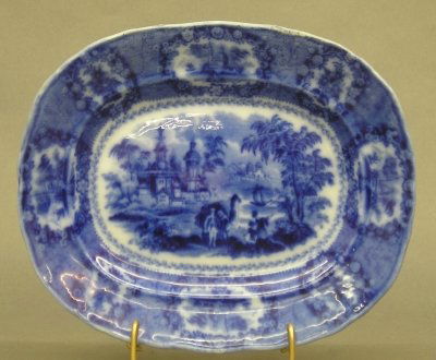 Ridgeway platter: A 19th century Ridgeway Flow Blue platter. "Oriental" pattern with medallion border. Printed and impressed marks. Minor wear. 9 1/4" long. ESTIMATE $100-150