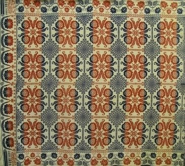 Coverlet: A 19th century American 2-part woven coverlet. Red, White and Blue Floral block design with "Vintage". Corner block reads "Wove by W Wolf, Shelby, Richland County, Ohio, 1853". Wear, staining, some lo