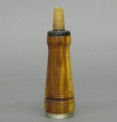 Charles H. Perdew call: A Charles H. Perdew bird call. Turned wooded body stamped "Patented Nov. 2, 1909, Charles H. Perdew, Henry, ILL". Some wear, lacks mouthpiece. 5 1/2" high. ESTIMATE $200-300