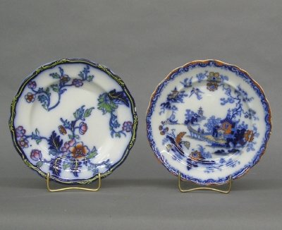 2 decorated Ironstone plates: Two 19th century Ironstone plates with Blue transfer designs and polychrome detail. Various makers. Some wear, crazing, one with short hairline. Each 9" diameter. ESTIMATE $50-100
