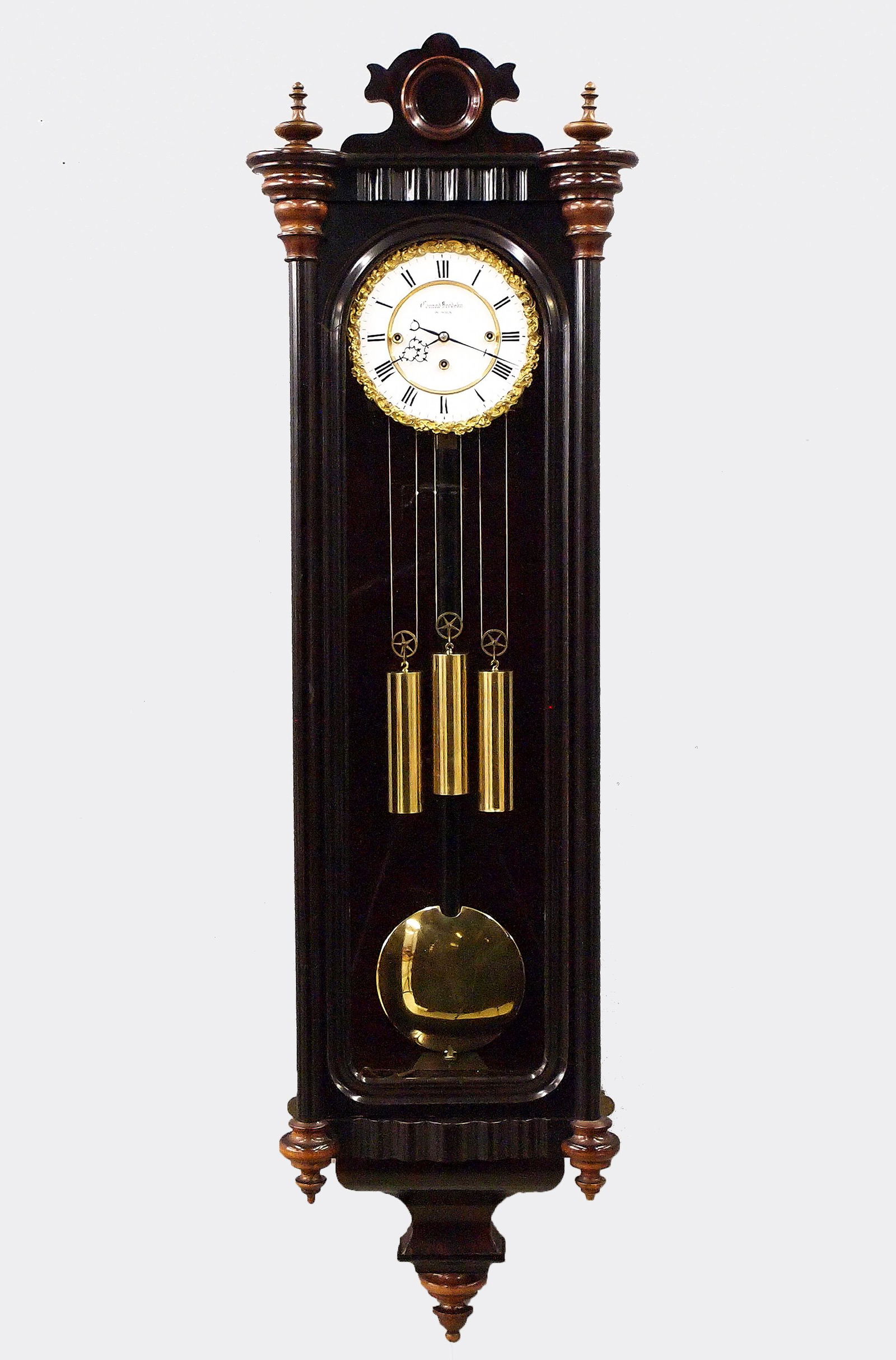 3 Weight Vienna Regulator: A mid 19th century Vienna Regulator wall clock. 8-day weight driven movement with quarter hour Grand Sonnerie strike, having a two-part porcelain dial with Roman numerals marked "Conrad Brodsky, In Wi
