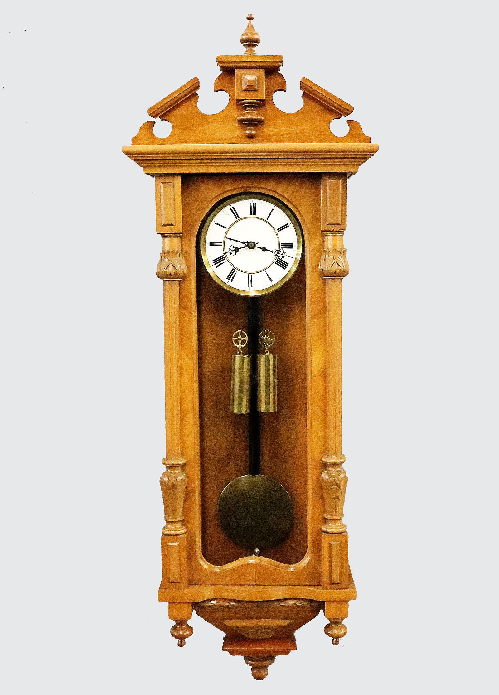 2 Weight Vienna Regulator: A late 19th century Vienna Regulator wall clock. 8-day weight driven time and movement having a two-part porcelain dial with Roman numerals and molded Brass bezel. Walnut case with shaped crest over a