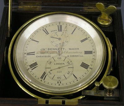 Bennett Marine Chronometer: A late 19th century British Marine Chronometer by John Bennett, London. 2-day chain driven fusee movement with a Silvered dial with seconds bit and UP/DOWN Wind indicator, marked "Jno Bennett Maker, t
