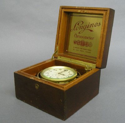 Longines Deck watch: An early 20th century Longines Deck watch. 1 day spring wound 17 jewel movement, adjusted to 3 positions, Silvered dial with seconds bit and UP/DOWN Wind indicator, serial #6611337. In a Mahogany lift