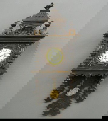 German Free swinger wall clock: A late 19th century German Free swinger wall clock. 8-day spring driven time and strike movement, with 2-part porcelain dial and "R-A" compensating pendulum. Oak case with single door, applied pilaste