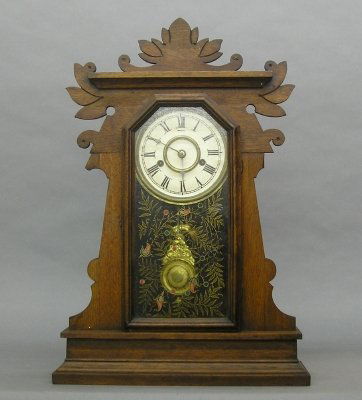 New Haven "Neried" model Kitchen Shelf clock: A turn of the century New Haven "Neried" model Kitchen Shelf clock. 30 hour spring driven time and strike movement. Walnut case with pressed carved detail and a single door with stenciled glass. Older
