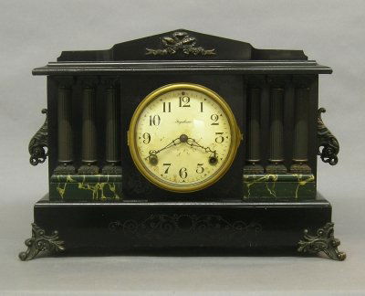 Ingraham Black Mantle clock: An early 20th century Ingraham Black Mantle clock. 8 day spring driven time and strike movement. Classic Greek Revival case with pediment top, columns, Metal mounts and Marbleized detail. Original Ebo