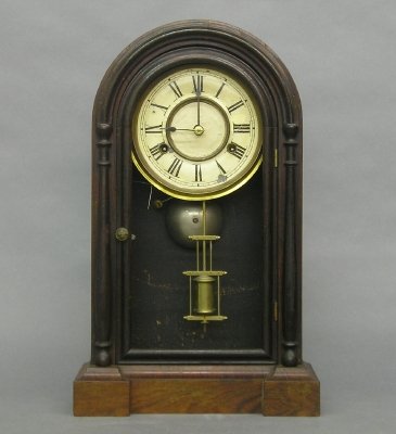 Jerome "Guide" model Shelf clock: A late 19th century Jerome "Guide" model Shelf clock. 8 day spring driven time and strike movement with painted metal dial. Rosewood case with Round top and single door with applied pilasters. Paper l