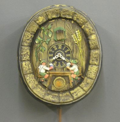 German Cuckoo wall clock: A 20th century German Cuckoo wall clock. Molded plastic case with tavern scene. Weight driven movement with animated drinkers. Some case damage. 14 1/2" high. ESTIMATE $50-75