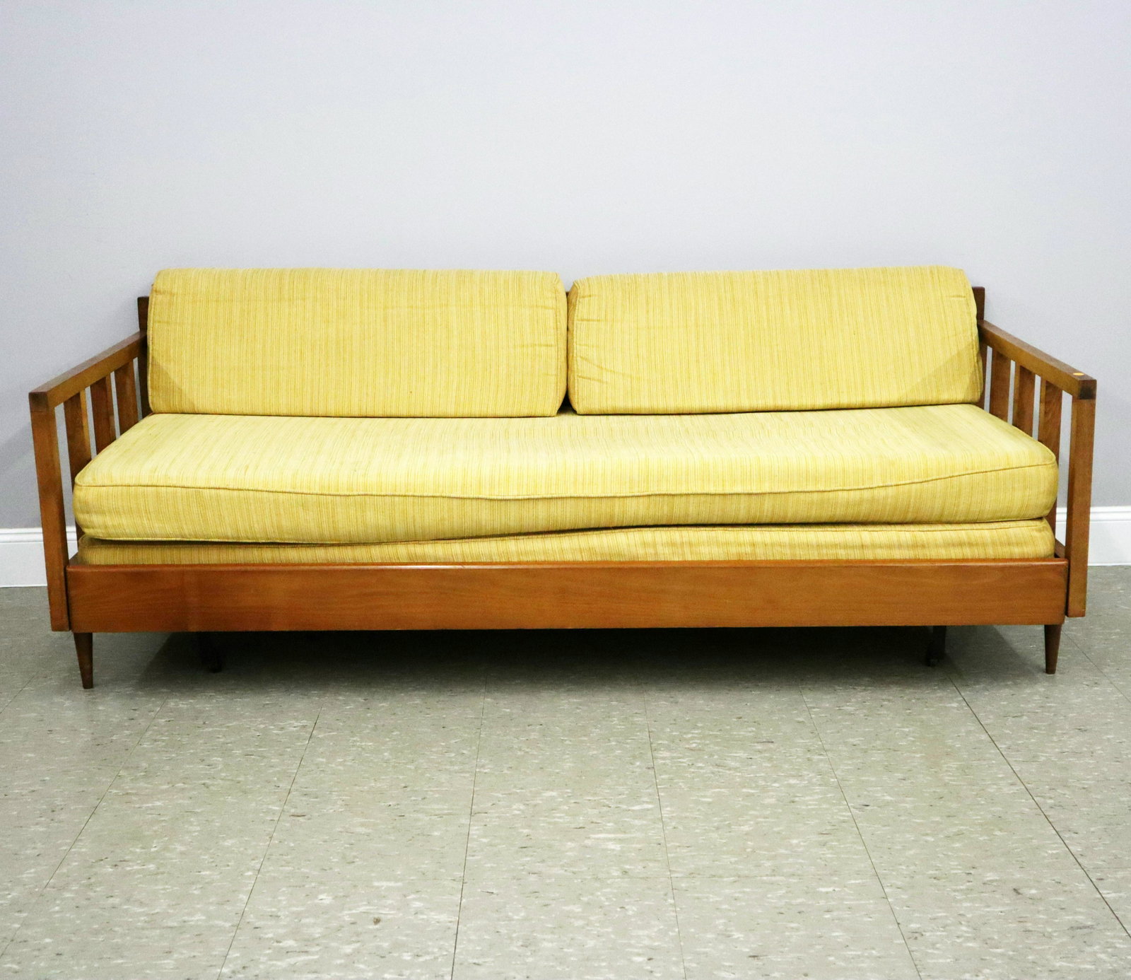Maple Sofa with Trundle: A mid 20th century sofa with pullout trundle bed. Maple construction with removable seat, back and trundle cushions in multi-tone Mustard Yellow upholstery. Some wear to frame, discoloration to uphols