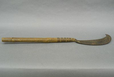 Philippine Sugar Cane Machete: An 18th century Philippine Sugar Cane Machete hand forged sickle shaped blade with 5 wrought iron bands on a bamboo handle. Heavy wear with dark patina on all metal surfaces. 32 1/2" long overall. EST