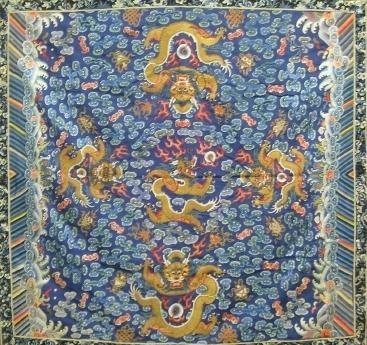 Chinese Embroidered Table Cover: Mid 19th century Chinese Embroidered Table Cover with five 5 toed embroidered gold thread dragons. Multi-colored embroidered patterns on a blue background including clouds, flaming pearl, bats, etcete