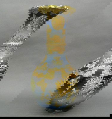 Japanese Satsuma vase: A turn of the century Japanese earthenware Satsuma vase. Ruffled top with slender neck and bulbous base with molded and applied decoration on a Deep Blue ground with Gilded detail. Signed in Character