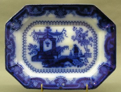 Flow Blue platter: A 19th century Flow Blue platter. "Oregon" pattern by T.J. & J. Mayer. Printed and impressed marks. Knife marks, minor glaze imperfections. 13 3/8" long. ESTIMATE $300-500