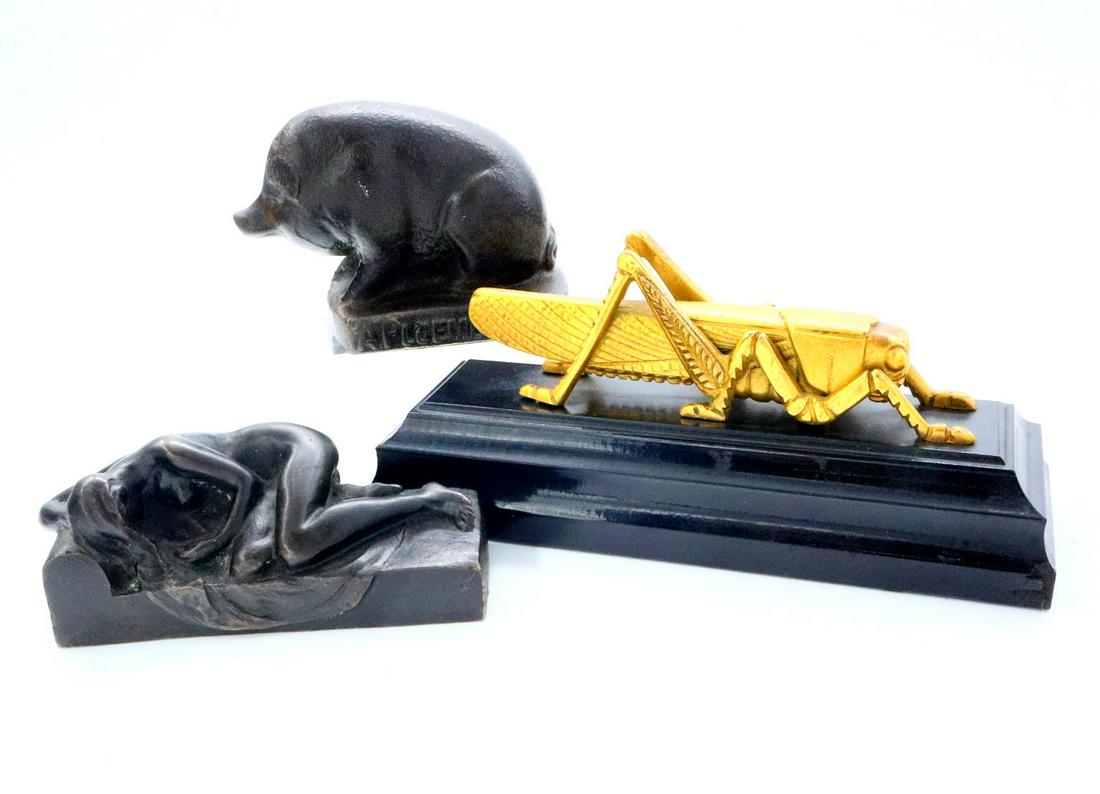 3 Cast Paperweights: Three 19th and 20th century cast metal paperweights. Includes a Bronze reclining nude with illegible signature, a cast Iron Pig marked "A. Pluemer & Co. " and "Cin'Ti.O", and a Gilded Brass Grasshoppe