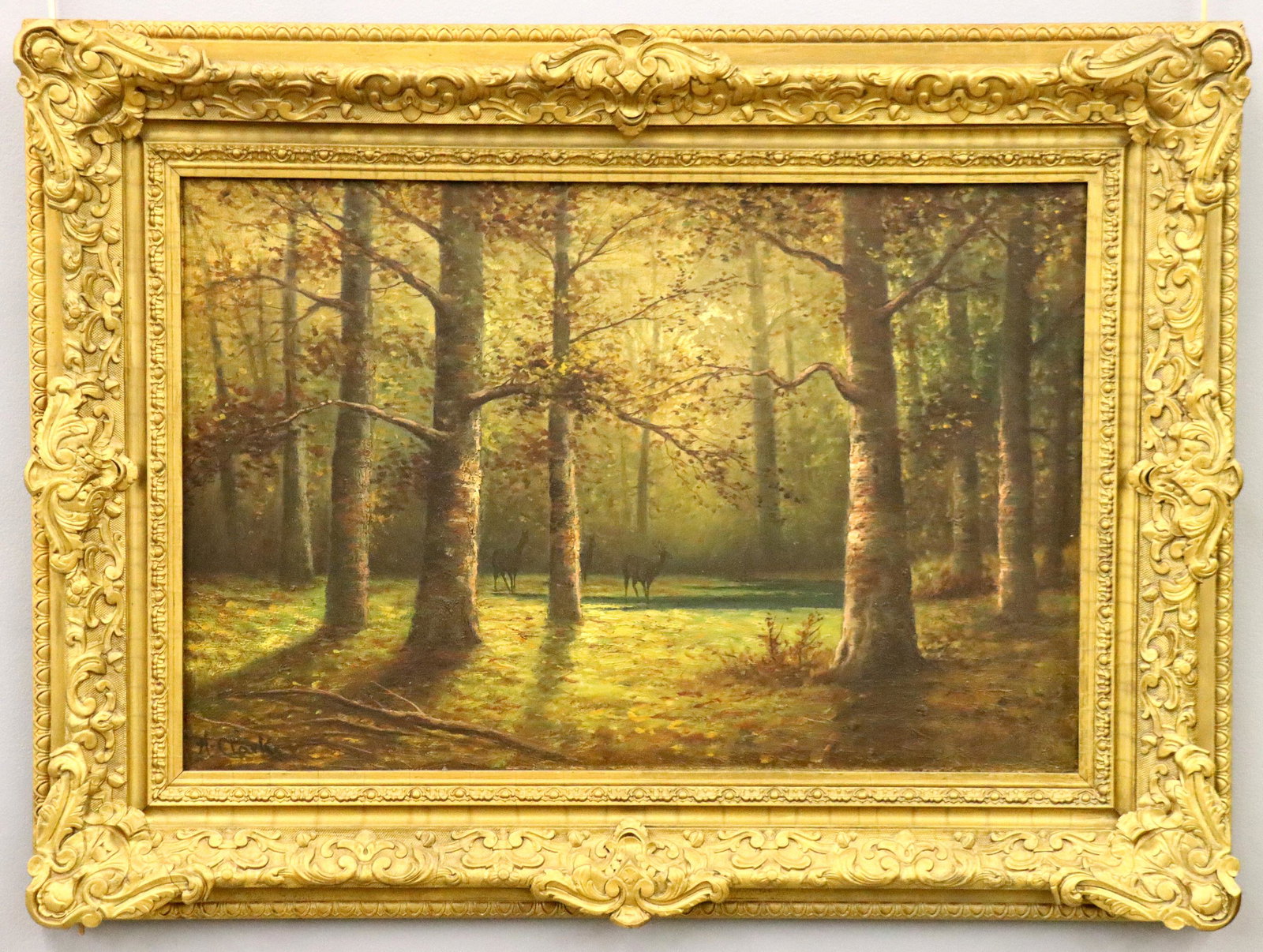 A. Clarke Landscape: An early 20th century British oil on canvas landscape. Depicts deer watering in a dense Beech forest. Signed "A. Clarke" (n.d) lower left. Some surface grunge, taped puncture center left. Image 20 1/2