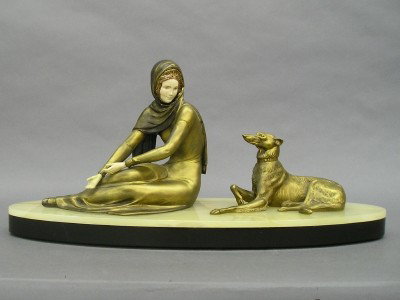 Art Deco figure: A 1930's Art Deco figure of a woman and dog by Uriano. Patinated Spelter figures on a Marble and Onyx base. Etched signature on base. Wear and minor damage. 23" long. ESTIMATE $300-500