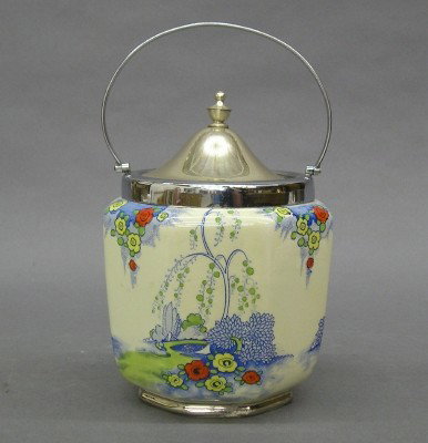 Biscuit barrel: A turn of the century earthenware biscuit barrel with Chrome fittings. Multi color landscape design. Printed marks "Marina". Minor wear. 6" high. ESTIMATE $100-150