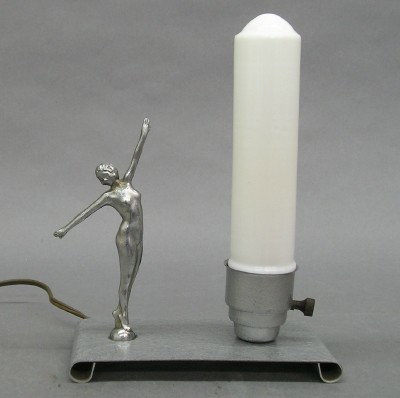 Art Deco light: An Art Deco figural light. Chrome nude female figure on a painted steel base with milk glass shade. Some surface wear. 9 1/2" high. ESTIMATE $100-150