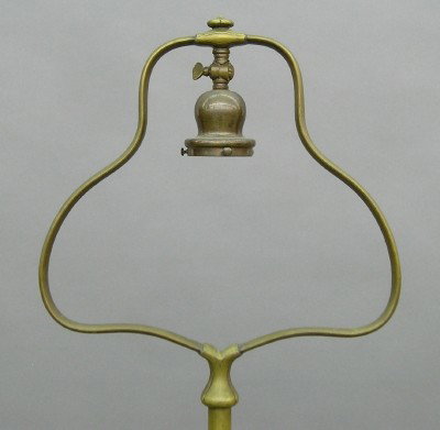 Handel floor lamp base: An early 20th century Handel Bronze floor lamp base. Harp type with bell shaped harp and adjustable swivel socket and molded circular base. Wear and surface scratches, lacks label. 57" high. ESTIMATE 