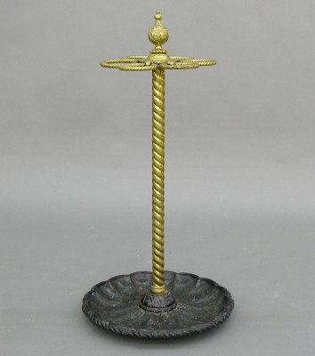 Victorian umbrella stand: A 19th century Victorian Period Brass and Iron umbrella stand. Roped Brass design with upper rack and lower Iron drip pan. Some wear, base repainted. 28" high. ESTIMATE $200-400