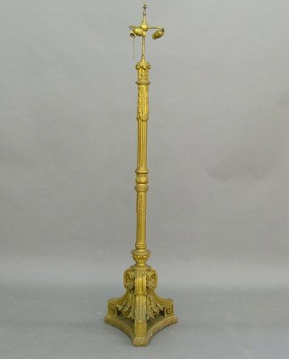 Gilded floor lamp: An early 20th century Neoclassical gilded floor lamp. Wood and gesso with garlands, a fluted stem and tri-footed base. Wear and some damage. 73" high overall. ESTIMATE $400-600