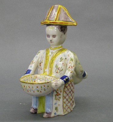 Faience figural salt: A 19th century Faience master salt. Figural design with hand painted decoration. Wear and some small edge flakes. 6 3/4" high. ESTIMATE $200-300