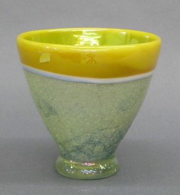 Leon Applebaum bowl: Leon Applebaum, born Toledo, Ohio 1945, Art Glass footed bowl. Simple tapered form with mottled Blue base and a Yellow rim and lining. Etched signature "Leon Applebaum". Slight wear. 5 3/4" high. ESTI