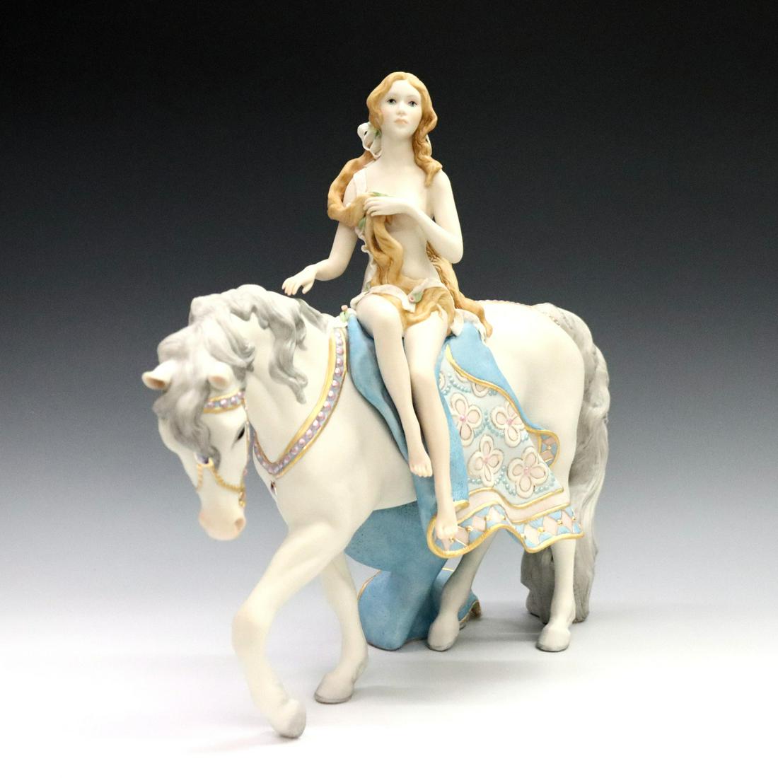 Cybis Lady Godiva Figure: A late 20th century Cybis "Lady Godiva" bisque porcelain figure. Depicts the Lady Godiva nude on horseback in pastel tones with Gilded accents. Painted mark. Minor wear. 14 1/2 x 4 1/4 x 13" high over
