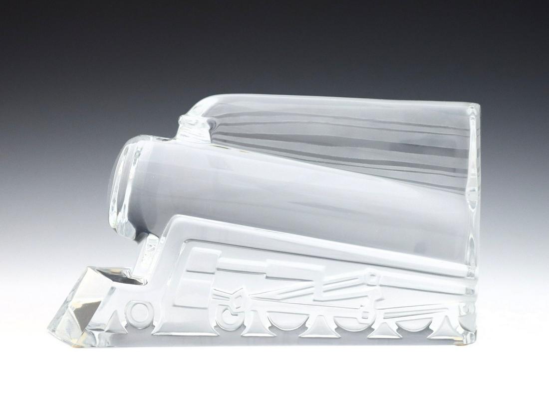 Daum Pacific Steam Engine Crystal Sculpture: A late 20th century Daum "Pacific Steam Engine" Crystal sculpture designed by Xavier Froissart. Molded train form with frosted detail in hollow relief. Etched "Daum France" signature at front. Minor w