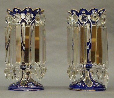 Pair of Bohemian lustres: A pair of early 20th century Bohemian glass lustres. Blue/White cased glass with cut to clear designs and glided detail. Restored prisms, worn gilding, minor edge roughness. Each 10" high. ESTIMATE $6