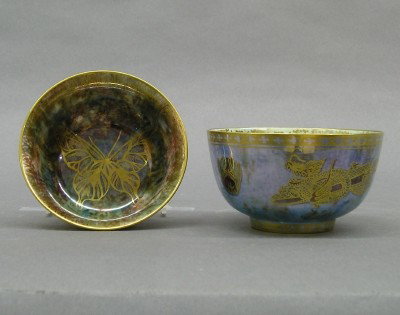 2 Wedgwood luster bowls: Two early 20th century Wedgwood luster ware bowls. Mottled glazes, decorated with Butterflies/Dragons in hand gilded detail. Printed "Portland Vase" marks. Slight wear, one with restoration. Up to 4" 
