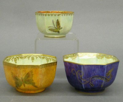 3 Wedgwood luster bowls: Three small early 20th century Wedgwood luster ware bowls. Octagonal bodies with mottled glazes, decorated with Butterflies/Dragons in hand gilded detail. Printed "Portland Vase" marks. Slight wear. U
