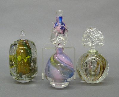 4 Leon Applebaum perfume bottles: Leon Applebaum, born Toledo, Ohio 1945, an Art Glass perfume bottle. All with multi color designs in clear glass. Etched signatures. Slight wear. Up to 5" high. ESTIMATE $50-100