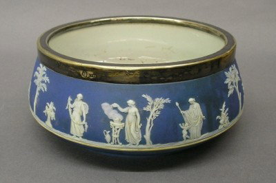 Wedgwood Jasperware bowl: A turn of the century Wedgwood Jasperware bowl with Silver plated rim. Blue Jasper dip body with Classical figures in White relief. Impressed mark "WEDGWOOD" only. Minor wear, surface discoloration. 8