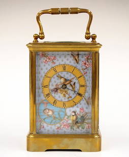 French Carriage Clock: An early 20th century French carriage clock. 8-day time only movement with hand painted porcelain dial, Gold chapter ring and Roman numerals. Brass case with swing handle, molded top and base,